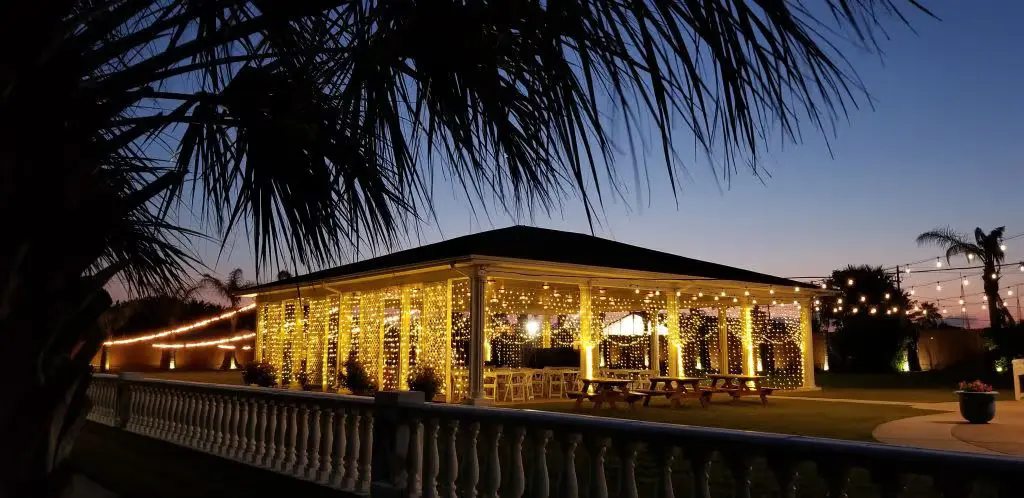 Outdoor event venue decorated with warm string lights at night